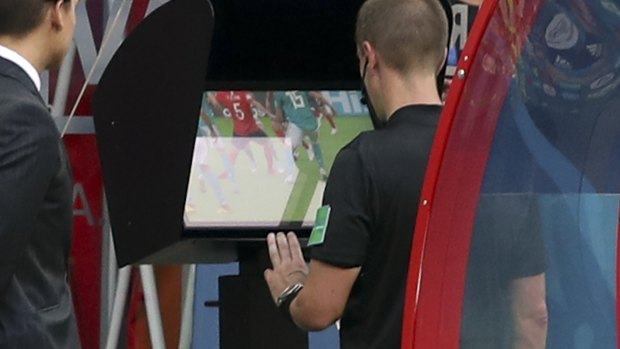 New era: Referee Mark Geiger using VAR in the match between South Korea and Germany.