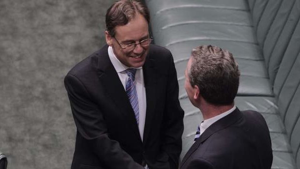 Environment Minister Greg Hunt is congratulated by Leader of the House Christopher Pyne after the Carbon Tax Repeal bills passed the House on the voices at Parliament House on Thursday 21 November 2013. Photo: Andrew Meares