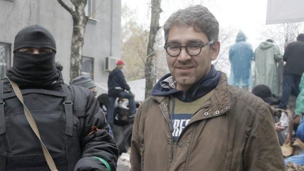 Captive ... US reporter Simon Ostrovsky, right, stands with a Pro-Russian gunman at seized police station in the eastern Ukraine town of Slovyansk. Pro-Russian gunman now claim to be holding the Vice News journalist.