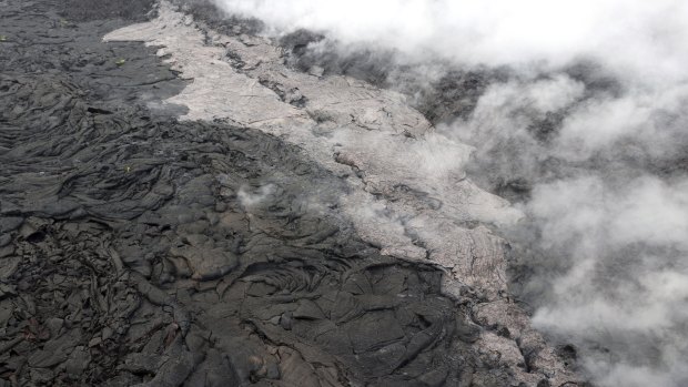 A lava flow (lighter in colour) and spatter that erupted from a section of the crack on the west flank of Puu Oo vent of Kilauea Volcano in Hawaii.
