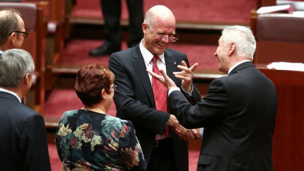 LDP Senator David Leyonhjelm is congratulated by Senator Doug Cameron after delivering his maiden speech. Photo: Alex Ellinghausen