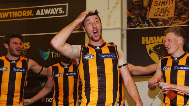 Hawks hero Jack Fitzpatrick sings the club song after the last-gasp win against Collingwood on Sunday. 