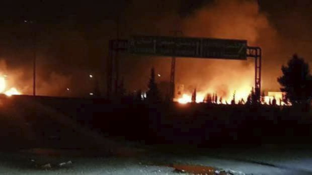 Flames rising after an attack in an area known to have numerous Syrian army military bases, in Kisweh, south of Damascus, Syria. Syrian state-run media said Israel struck a military outpost.