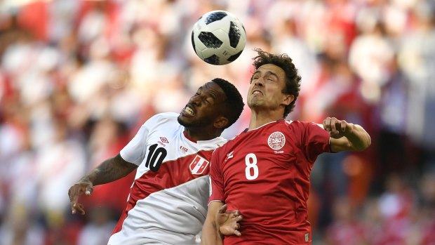 Box-to-box player: Thomas Delaney battles for the ball with Peru's Jefferson Farfan.