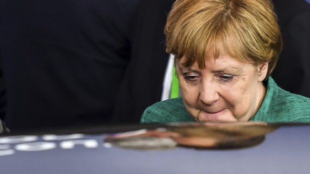 German Chancellor Angela Merkel leaves the EU summit in Brussels, early on Friday.