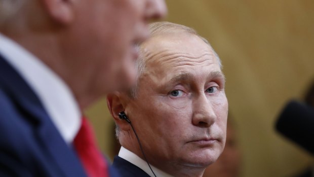Russian President Vladimir Putin listens to US President Donald Trump 