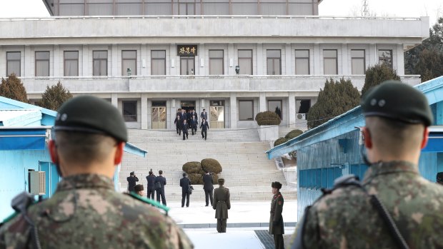 A North Korean delegation leaves for the south side in January as South Korean army soldiers stand guard at the demilitarised zone. 