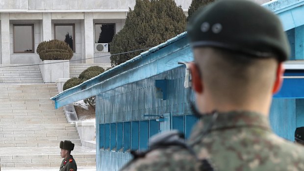 A North Korean delegation leaves for the south side in January as South Korean army soldiers stand guard at the demilitarised zone. 