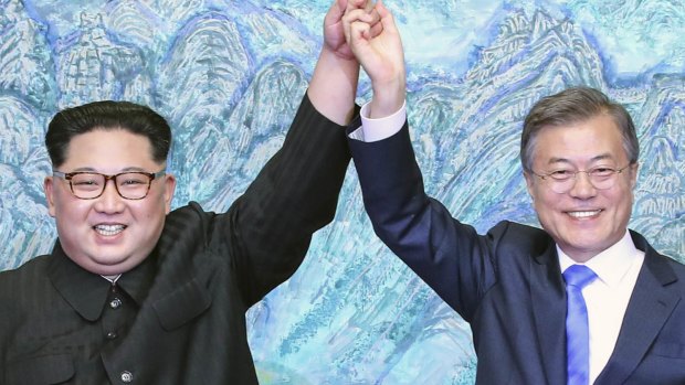 North Korean leader Kim Jong-un, left, and South Korean President Moon Jae-in raising their hands after signing a joint statement at the border village of Panmunjom in the Demilitarized Zone, South Korea. 