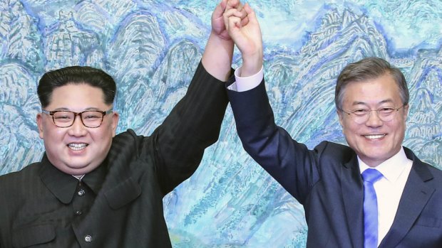 North Korean leader Kim Jong-un, left, and South Korean President Moon Jae-in raising their hands after signing a joint statement at the border village of Panmunjom in the Demilitarized Zone, South Korea. 