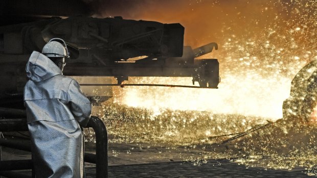 A steel worker watches the hot metal  at the Thyssenkrupp steel factory in Duisburg, Germany. 