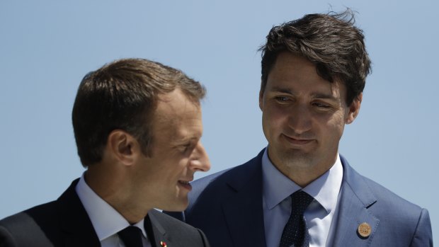 French President Emmanuel Macron is greeted by Canadian Prime Minister Justin Trudeau