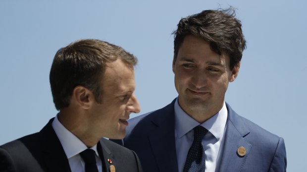 French President Emmanuel Macron is greeted by Canadian Prime Minister Justin Trudeau