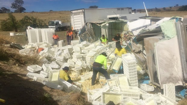 Yass Valley Council workers work to clean up after the crash.
