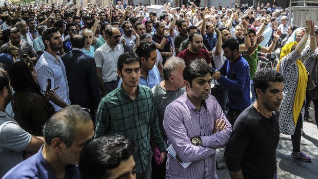 A group of protesters chant slogans at the old grand bazaar in Tehran, Iran.