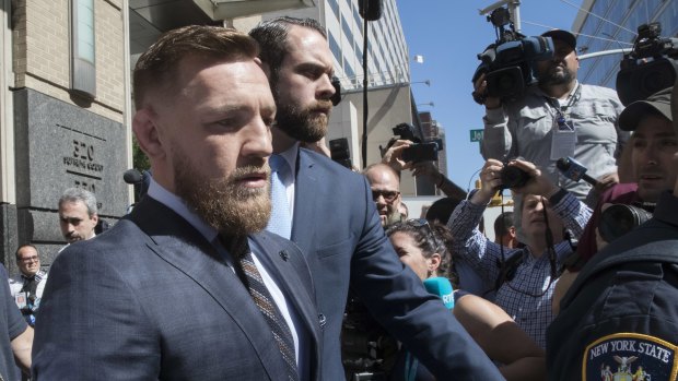 McGregor is escorted from court in Brooklyn. 