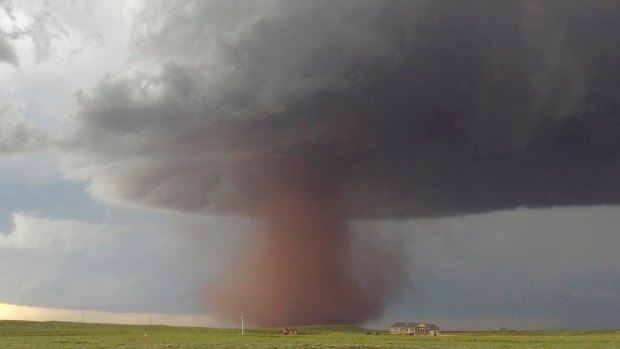 A tornado moving slowly across the plains north of Laramie, Wyoming. 