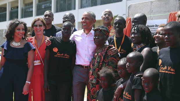 Barack Obama, centre, with his step Grandmother Sarah, centre right, his half sister Auma, third right, along with children and  officials, during an event in Kogelo, Kenya, on Monday.