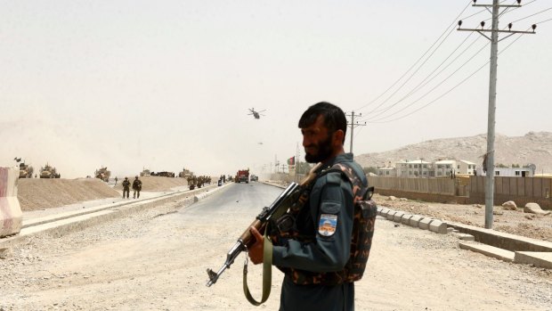 An Afghan policeman stands guard in Kandahar southern of Kabul, Afghanistan.