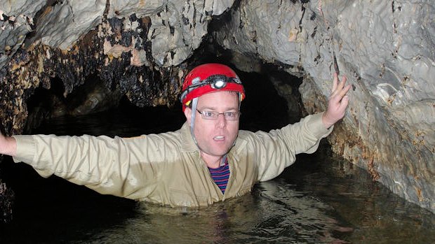 Tim explores the river cave.