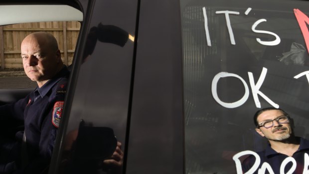 Mica Paramedic Collin Jenner (left) and Nic Santeloudi with a message of protest written on their car.