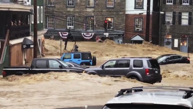 Water rushes through Main Street in Ellicott City, Maryland.