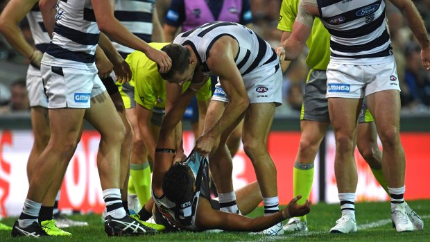 Willing contest: Port\'s Lindsay Thomas and Cat Joel Selwood wrestle.