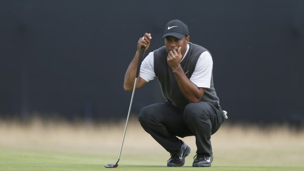 Tiger Woods lines up a putt on the 13th green.