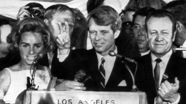 In this June 5, 1968 file photo, presidential hopeful Senator Robert F. Kennedy waves goodbye to his supporters as he prepares to leave the Ambassador Hotel ballroom in Los Angeles, before exiting through a kitchen backatage. 