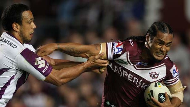 Centres clash: Melbourne's Will Chambers tries to rope in Manly counterpart Steve Matai.