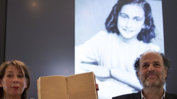 Teresien da Silva, left, and Ronald Leopold of the Anne Frank Foundation show a facsimile of Anne Frank's diary with two pages taped off during a press conference at the foundation's office in Amsterdam, Netherlands.