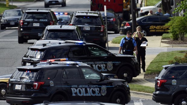 Police surround the Capital Gazette building after the shooting. 