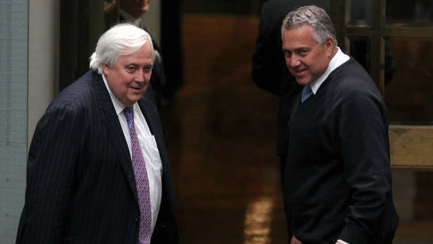 Palmer United Party leader Clive Palmer and Treasurer Joe Hockey depart after the Carbon Tax Repeal Bill passes the lower house. Photo: Alex Ellinghausen