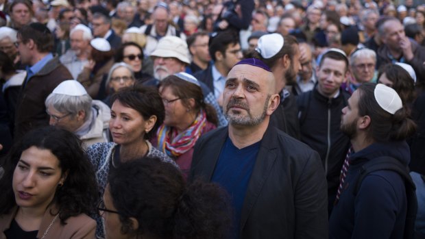 People wear Jewish skullcaps during a demonstration against anti-Semitism in Berlin.