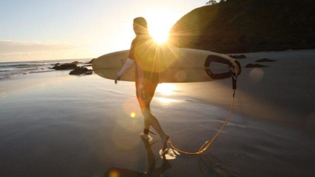 A surfer hits Watego's Beach at Byron Bay.