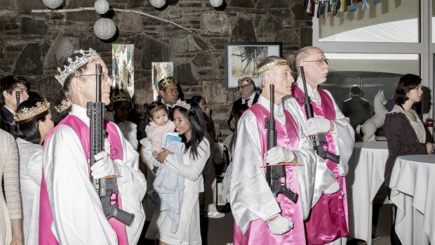 Church attendants hold their assault rifles during a sermon.