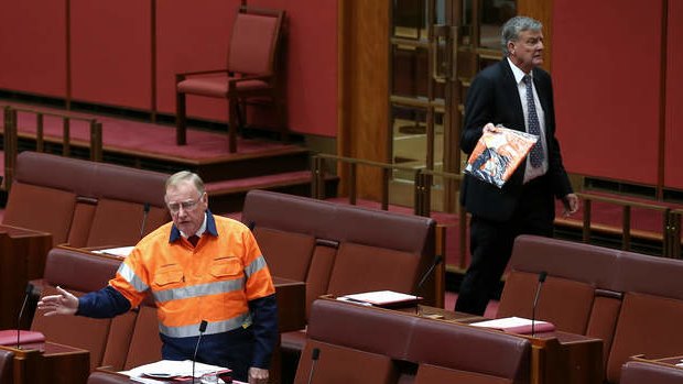 Liberal Senator Ian Macdonald speaks on the mining tax repeal as Bill Heffernan storms off. Photo: Alex Ellinghausen