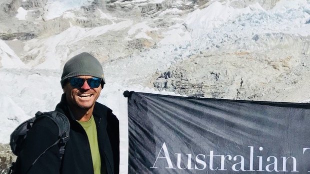 Mountain men: Paul Harragon and Mark Hughes fly the ATC flag in front of Mount Everest last year.