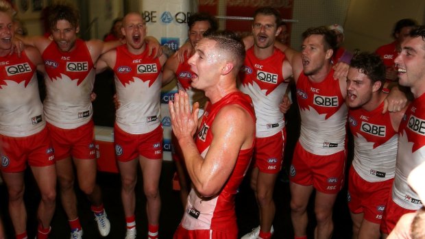 Sydney Swans first gamer Ben Ronke sings the team song after his first win. 