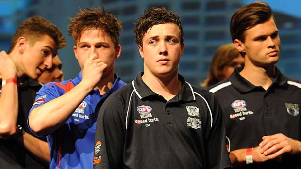 Nervous tension ... Lewis Taylor and others look on before the draft.