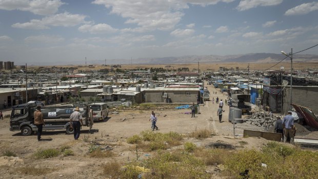 People walk in the Domiz camp for Syrian refugees, near the town of Dohuk, northern Kurdistan, Iraq.