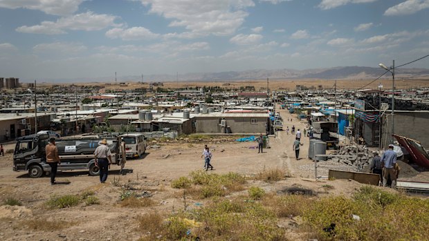 People walk in the Domiz camp for Syrian refugees, near the town of Dohuk, northern Kurdistan, Iraq.