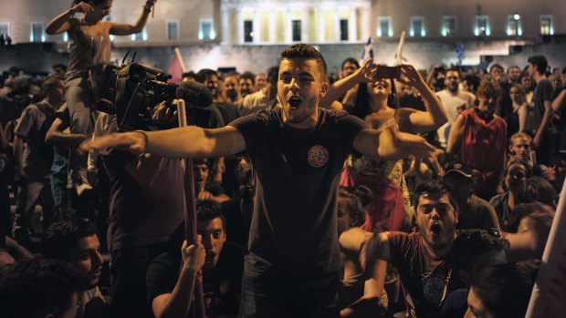 Supporters of the ruling Syriza party celebrate their victory in a referendum by the parliament in Athens, Greece July 5, 2015. Greeks voted overwhelmingly "No" on Sunday in a historic bailout referendum, partial results showed, defying warnings from across Europe that rejecting new austerity terms for fresh financial aid would set their country on a path out of the euro. REUTERS/Dimitris Michalakis