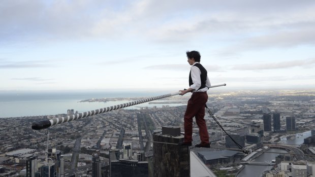 High wire artist Kane Petersen doing a 21m tightrope walk, 300m above the ground across the Eureka Tower's Skydeck. 