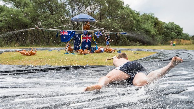 Hills Hoist Slide at Pine Island on Australia Day. Kaleb Dalla Costa tries to hold on as he spins around the slide. Photo: Dion Georgopoulos