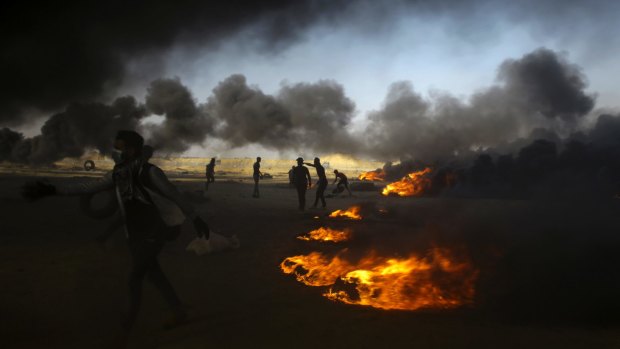 Palestinian protesters burn tires during a protest at the Gaza Strip's border with Israel.