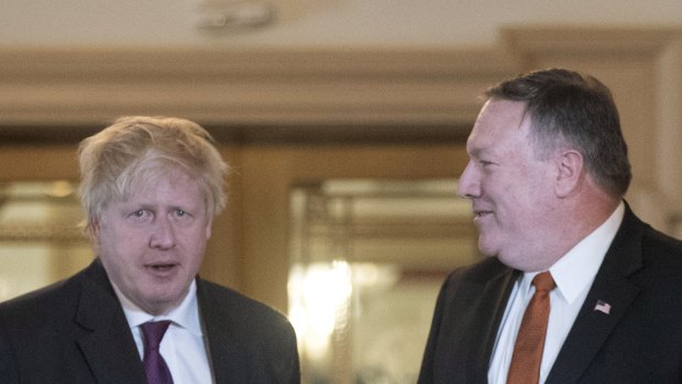Secretary of State Mike Pompeo and UK Foreign Secretary Boris Johnson arrive for a photo availability at the State Department in Washington. 