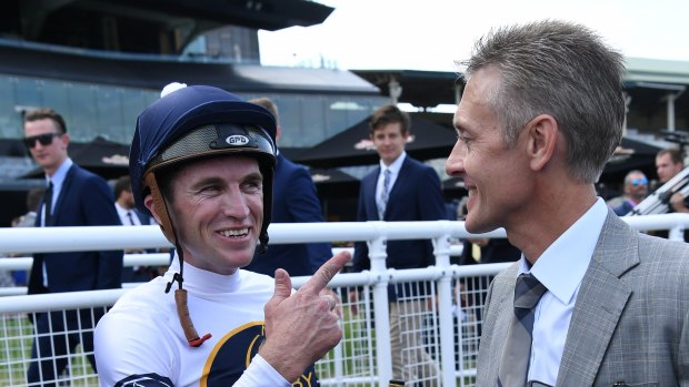 Ride on: Josh Parr in the Darby silks talks to Mark Newnham after a recent win from  Burning Passion.
