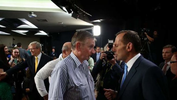 Prime Minister Kevin Rudd and Opposition Leader Tony Abbott meet participants after they attended the People's Forum at the Broncos Leagues Club in Brisbane.