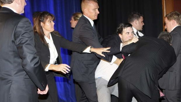 Security throw out the man who hopped on stage during Mr Abbott's speech at the Four Seasons hotel in Sydney.
